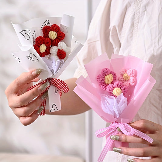 Two crocheted-flower paper bouquets: pink and red with plaid ribbons, held
