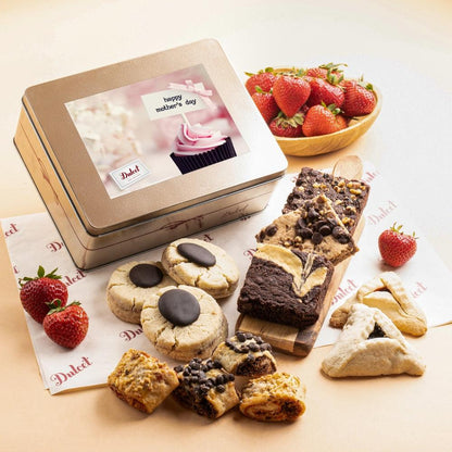 Gourmet cookie and brownie tin with assorted cookies and sliced strawberry garnish