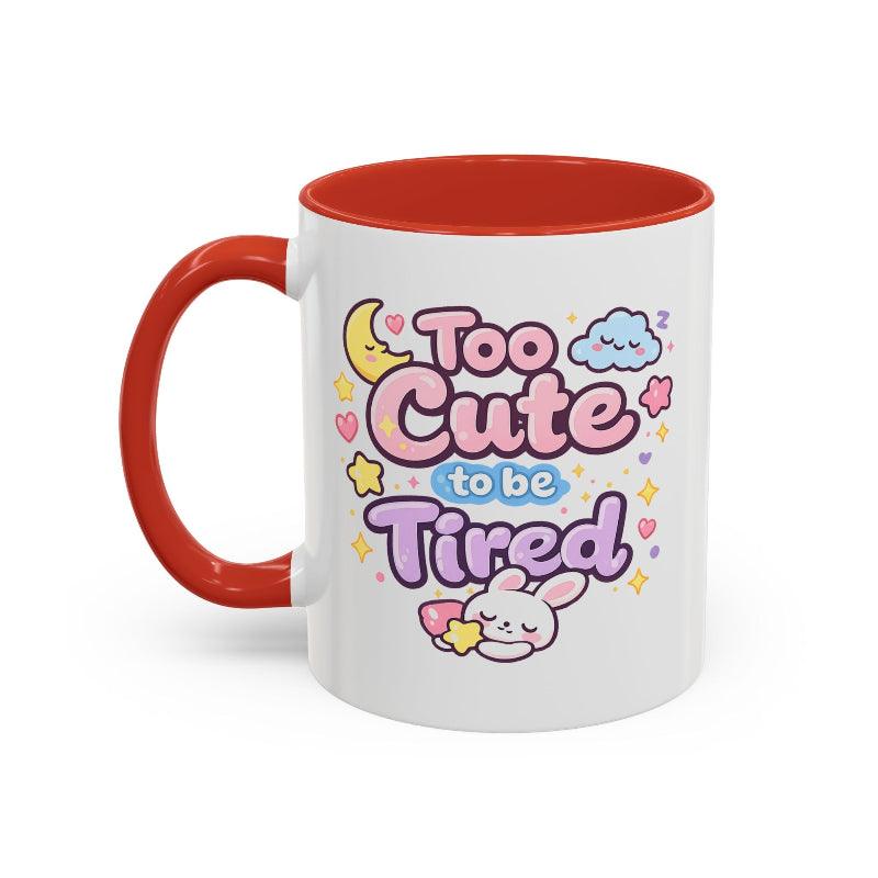 White mug with orange rim and handle, kawaii bunny “Too Cute to be Tired” graphic.