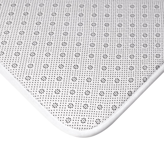 White bath mat with small starburst pattern and rounded memory-foam edge