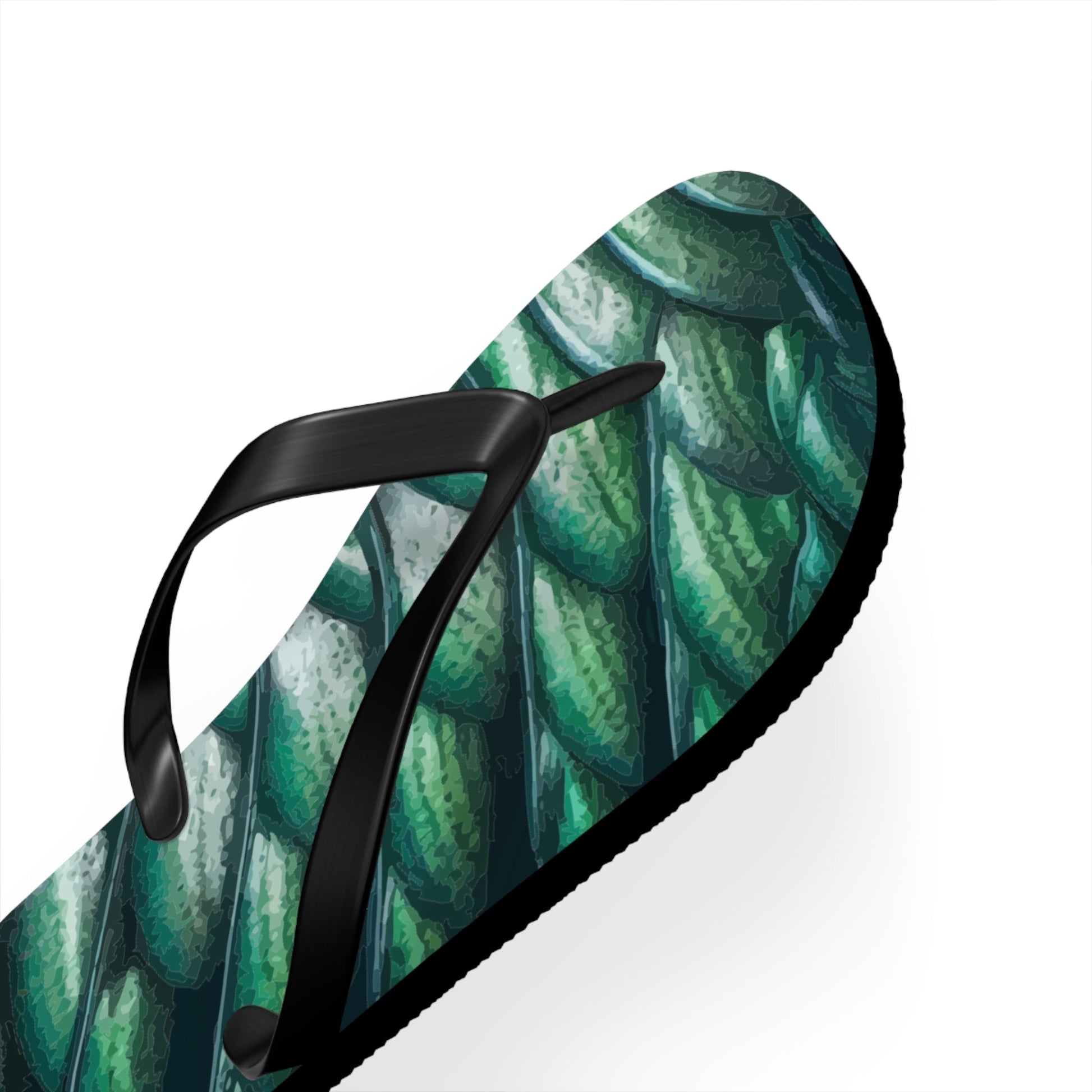 Close-up of green merman scales flip flop with black thong strap and edge sole