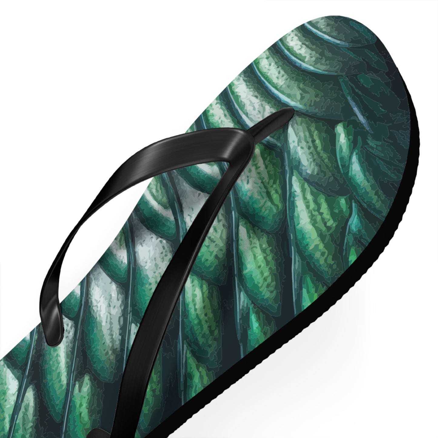 Close-up green scale-print flip-flop with black thong strap and textured sole