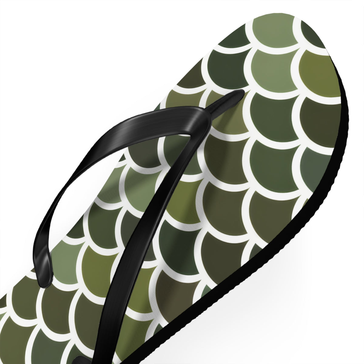 Close-up view of green scale print flip flop with black strap