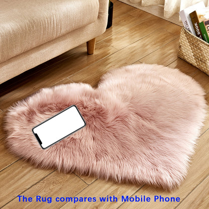 Heart-shaped faux fur rug with long shag pile, light pink plush carpet mat.