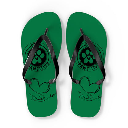 Green thong sandals with black straps and paw-print “PAWSITIVE” text on the upper