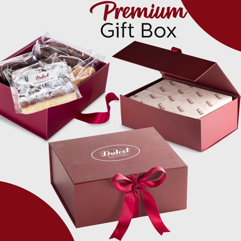Premium gift box with maroon lid and red ribbon, plus packaged cookie treats