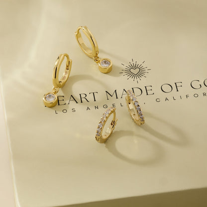 Gold diamond huggie hoop earrings with dangling charm