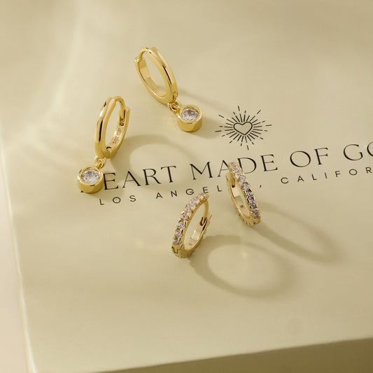Gold diamond huggie hoop earrings with dangling charm