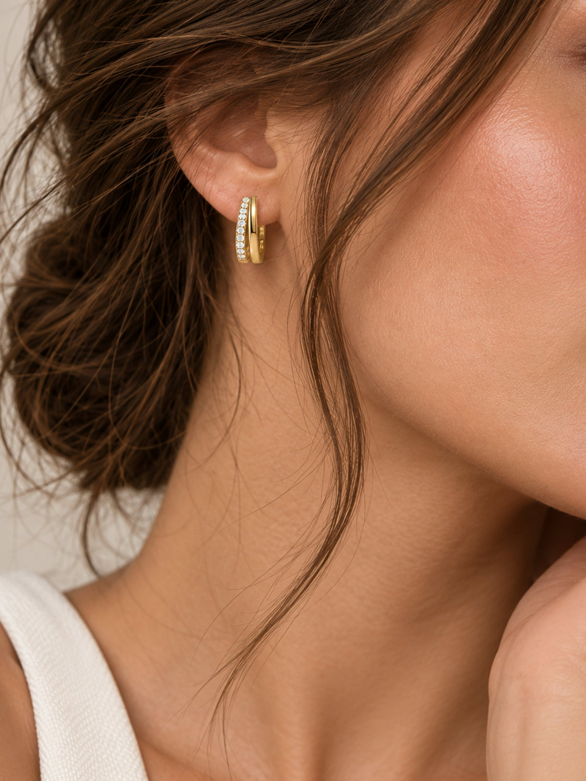 Gold double pave hoop earring with clear stones, side view on model ear