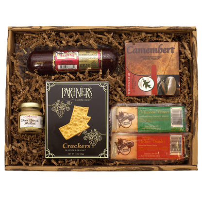 Charcuterie snack pack gift box with crackers, cheese, sausage, and spread jars.