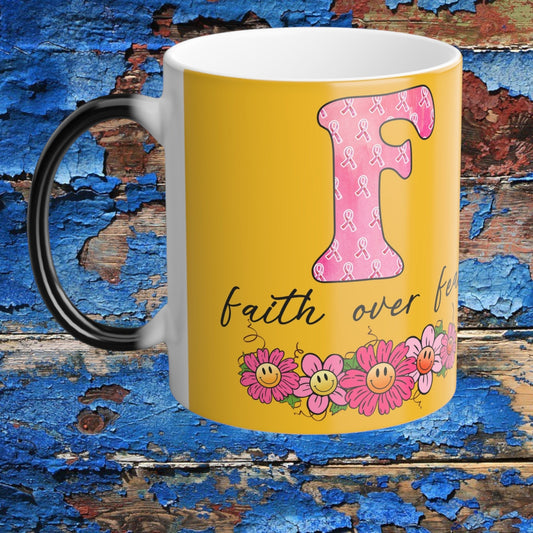 Color-morphing 11oz mug with yellow body, black handle, pink ribbon and floral “faith over fear”