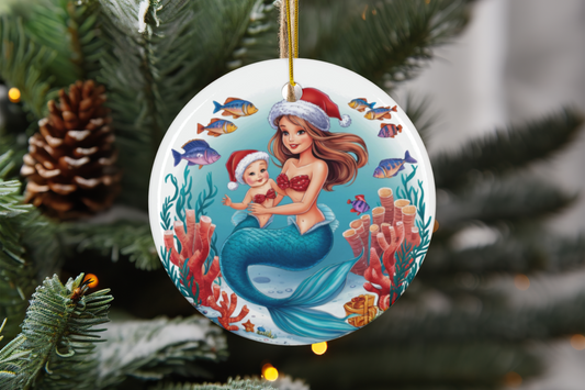 Round ceramic ornament with mermaid holding baby illustration on a white disk.
