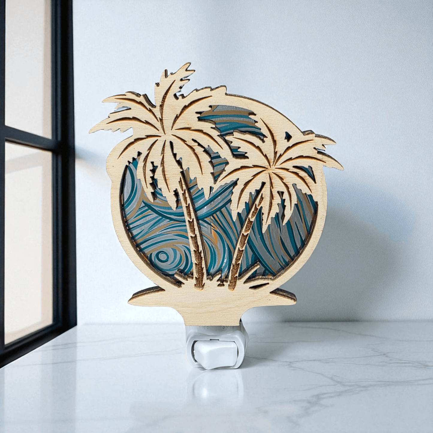 Palm tree LED night light close-up with blue wave palms and white base