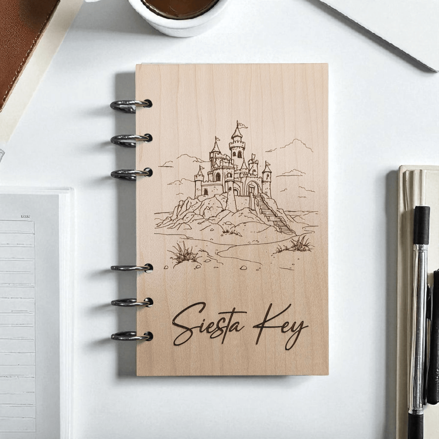 A6 refillable notebook front cover with black spiral rings, line-art castle and “Siesta Key” text