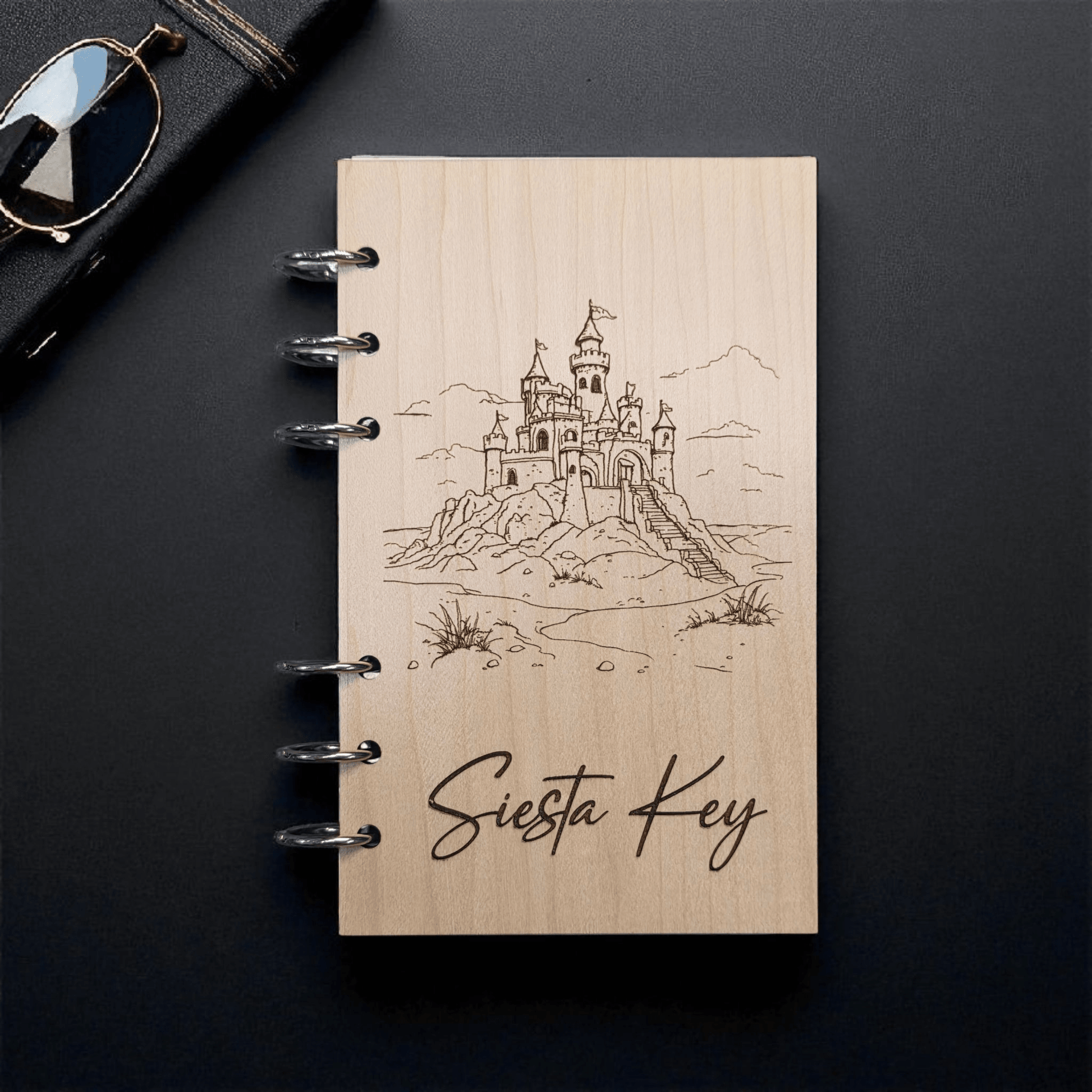 A6 refillable notebook, light tan cover with black spiral rings and “Siesta Key” script