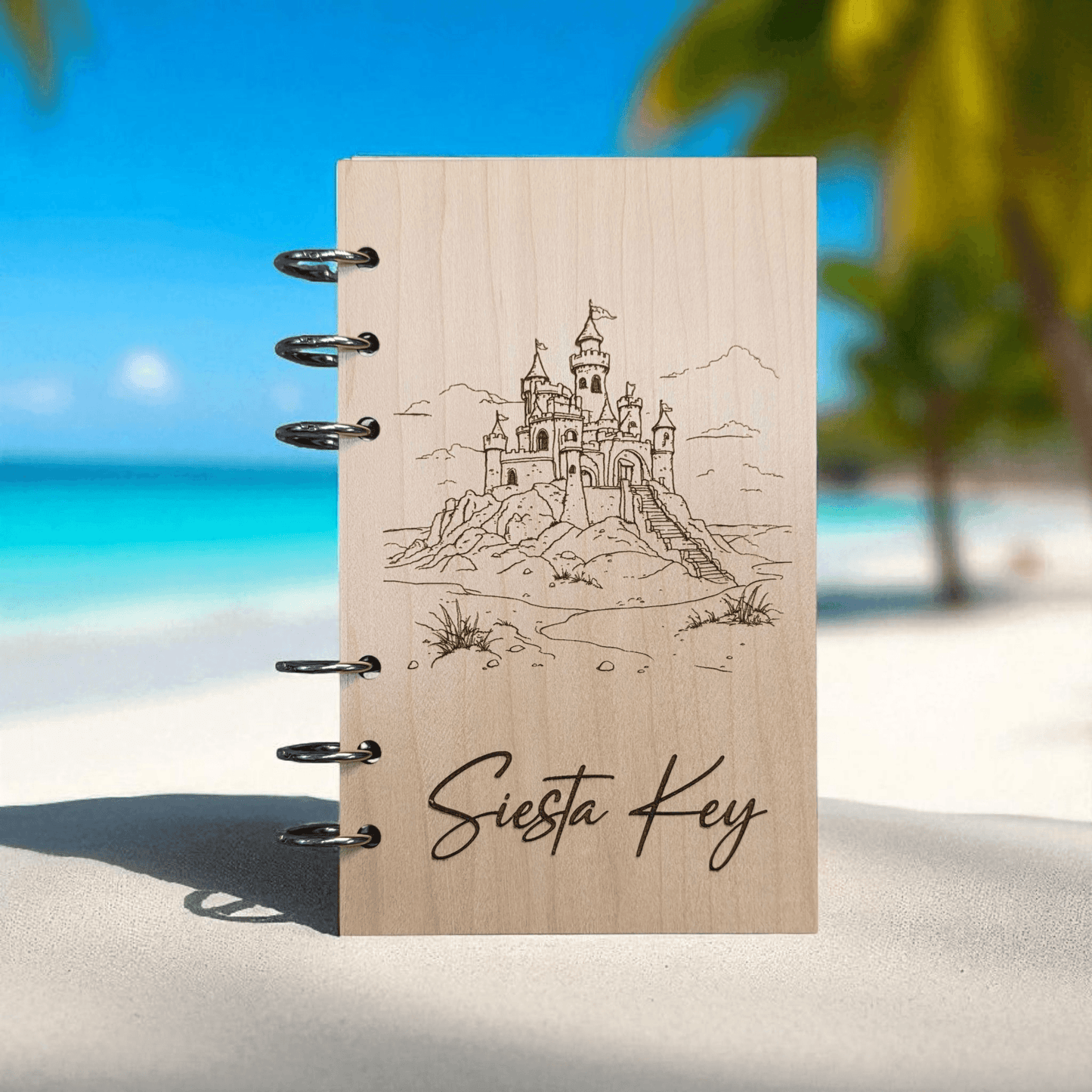 A6 refillable notebook with light tan cover, black spiral rings, line-art castle and “Siesta Key”