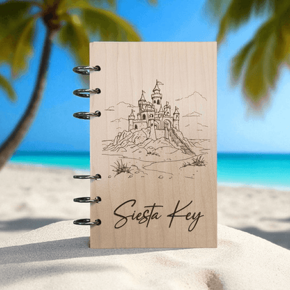 A6 refillable notebook with light tan cover, black spiral rings, line-art castle and “Siesta Key”