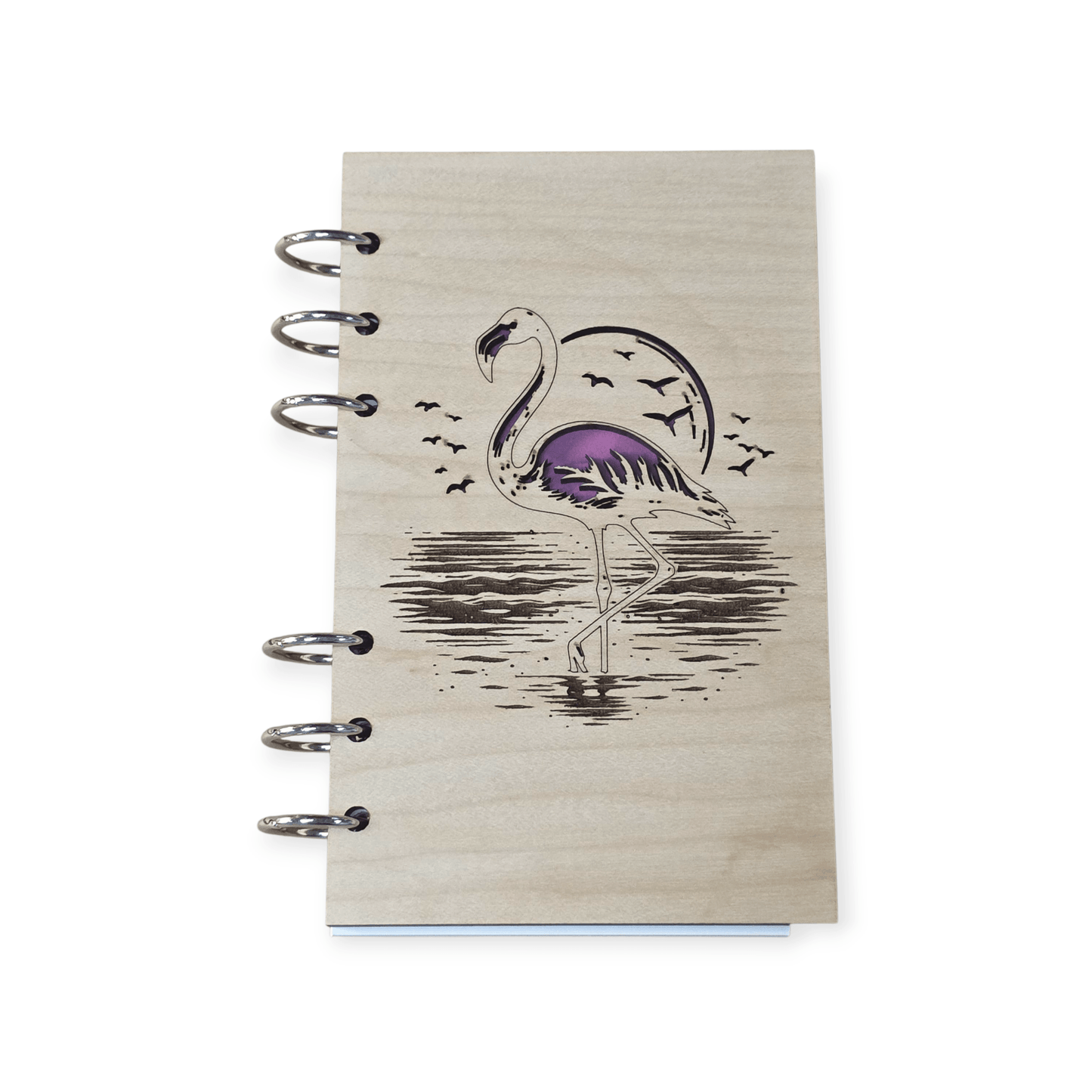 Closed A6 wood notebook journal with purple flamingo cover art and metal ring binding
