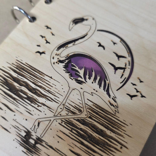Refillable notebook journal cover close-up with purple flamingo illustration and black birds