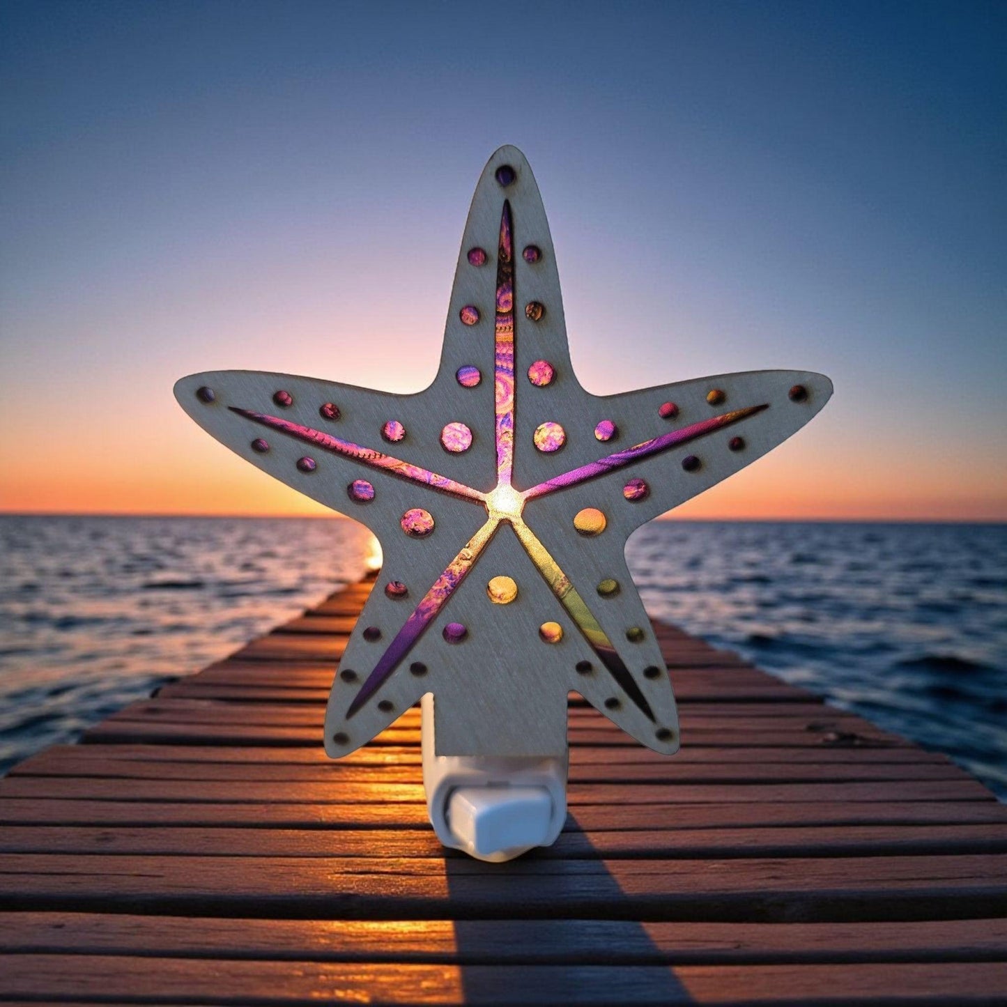 Starfish LED nightlight glowing on wooden deck