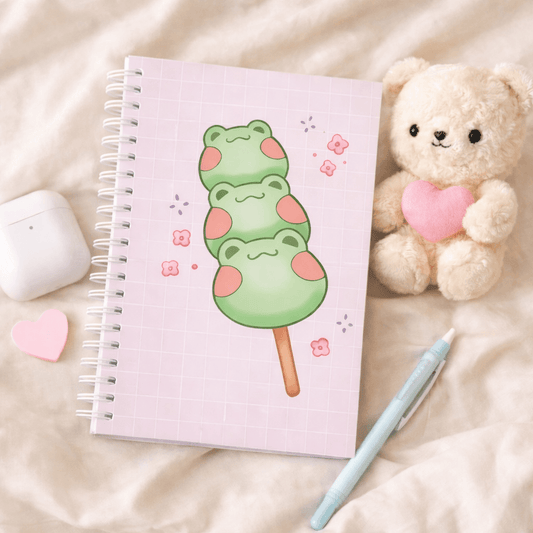 Square spiral notebook with lilac grid cover and green frog dango illustration