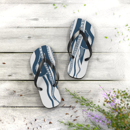 Blue octopus print flip-flops placed on outdoor wood boards with flowers