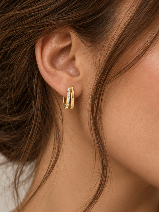 Gold hoop earrings with double pave row of clear stones, shown on ear