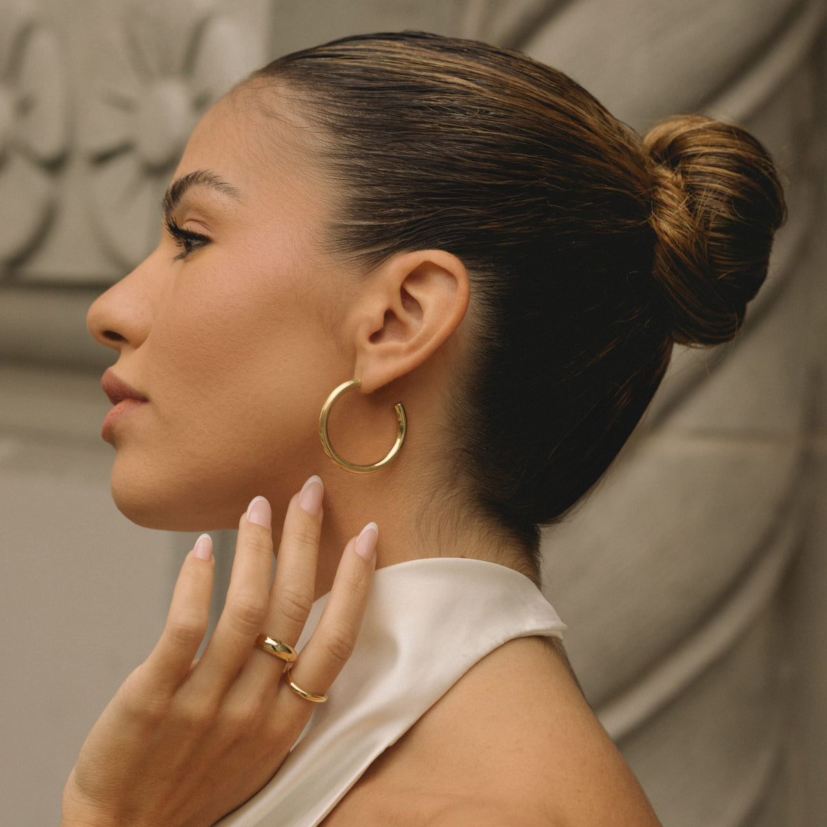 Gold-filled 30mm hoop earrings, smooth open hoops on ear from the side