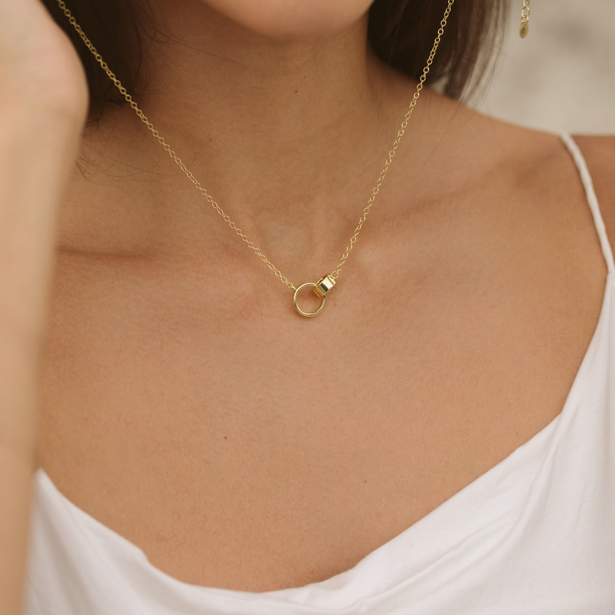 Gold-tone cable chain necklace with interlocking ring charm