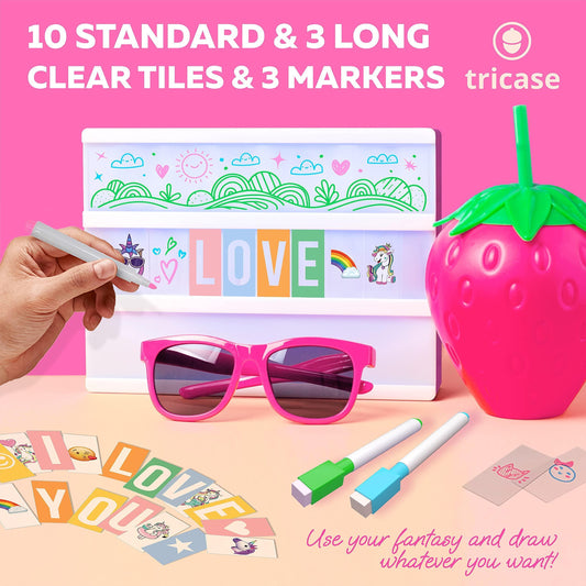 Pink light box with clear tiles and 3 markers, hand placing alphabet tile
