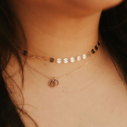 Layered gold-tone initial necklace with small E and B disc charms