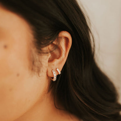 Gold-filled diamond hoops worn on an ear, shown from the side