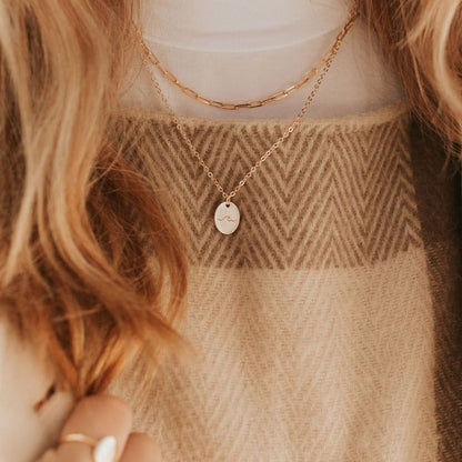 Gold-filled paperclip necklace layered above a fine pendant chain.