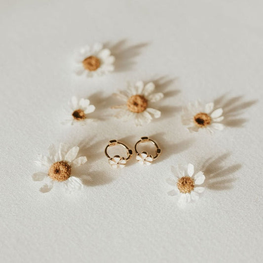 Gold mini hoop earrings with small white flower charms