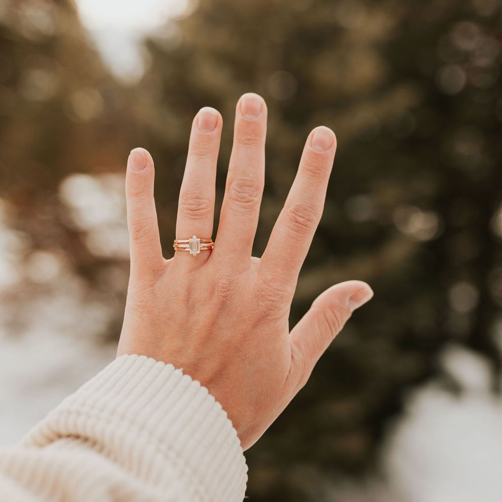 Gold filled stacking ring with a small clear stone between slim bands.