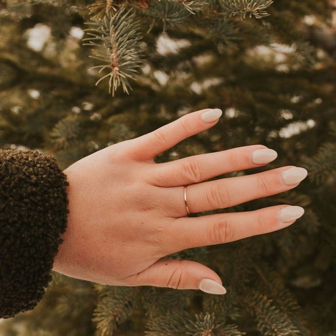 Gold filled stacking ring, a slim plain band worn on the finger.