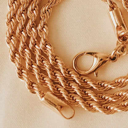 Gold-filled rope necklace clasp and twisted chain detail.