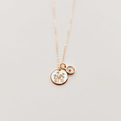 Gold-tone poppy necklace with engraved round pendant and mustard seed charm