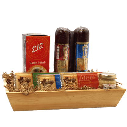 Rustic wooden gift crate with garlic herb crackers, salami bottles, and cheese items