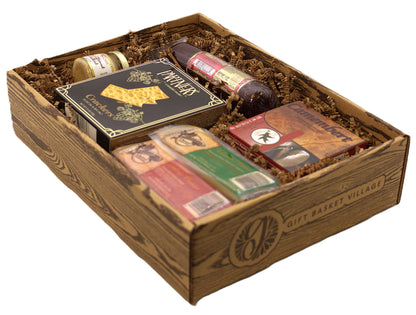 Charcuterie gift basket in a wooden crate with crackers, sliced cheese, and sausage.