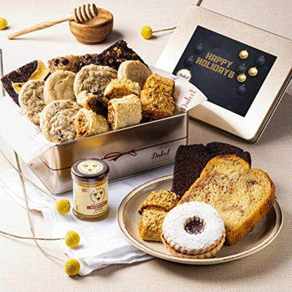 Assorted honey and pastry treats in metal tins with cake slices on a plate