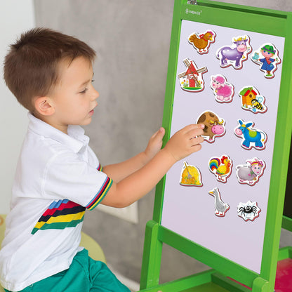 Child placing farm animal magnets on a green frame magnetic board