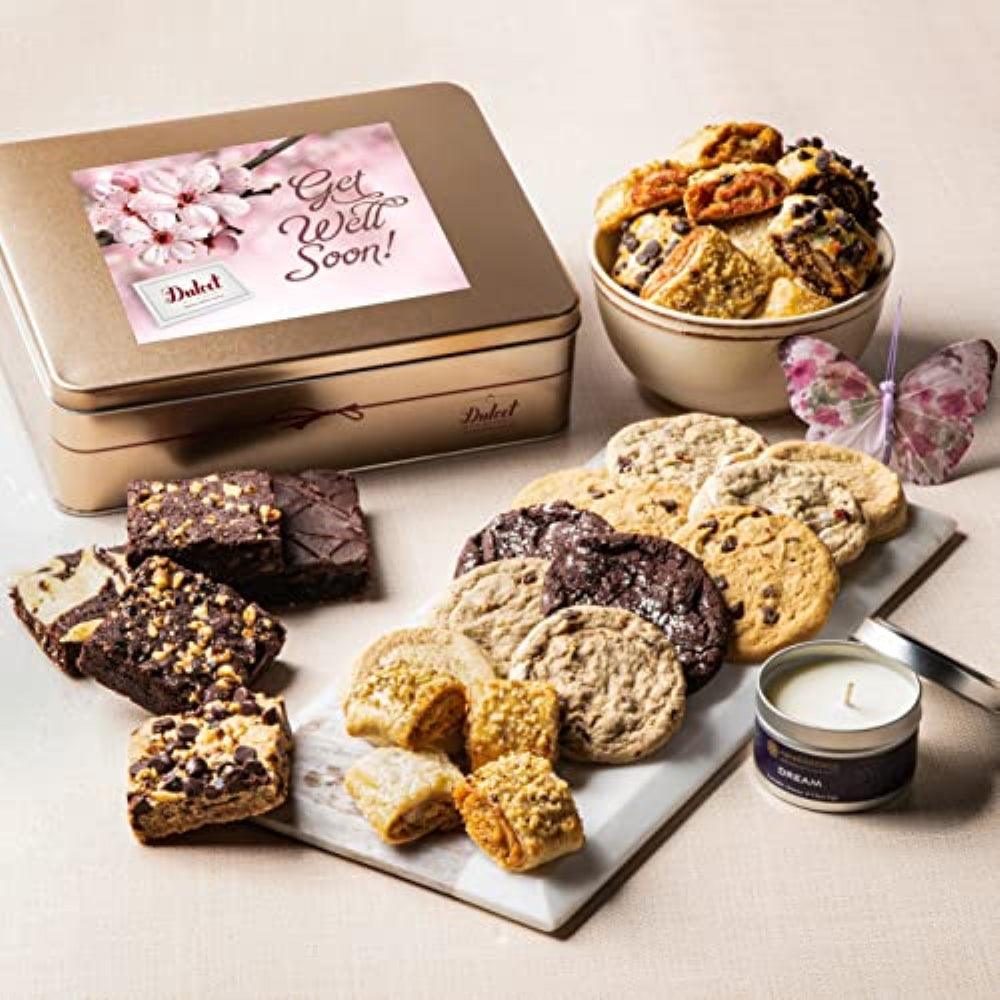 Open gift tin with assorted cookies, tin candle, and wrapped fruit pastries