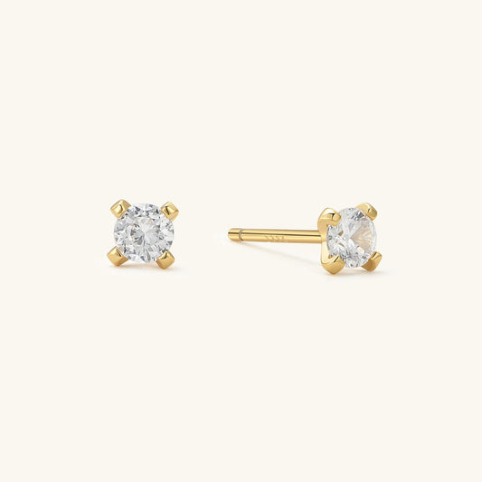 Gold-toned round CZ stud earrings with clear center stone, butterfly back visible