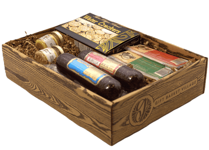 Gift basket with water crackers, cheese packs, and sausage links in a wooden crate