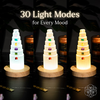 Three stacked-tier glow tower lamps on round wood bases, showing different colors