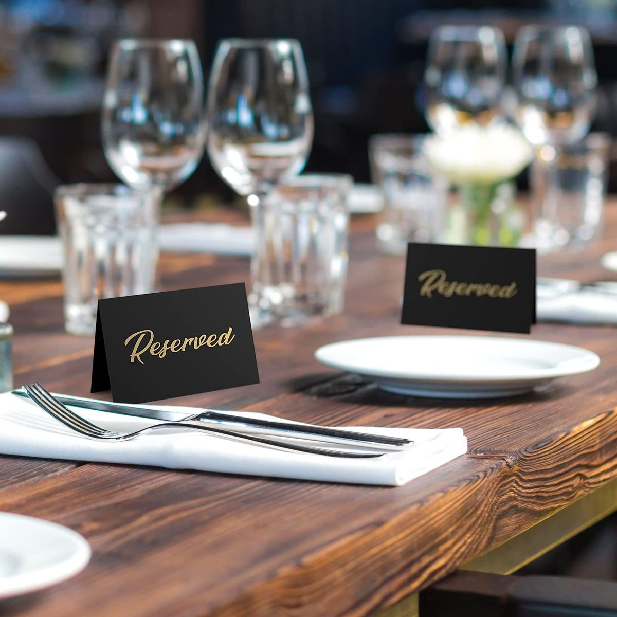 Banquet table with black tent signs featuring gold-foil “Reserved”
