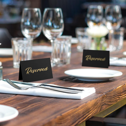 Banquet table with black tent signs featuring gold-foil “Reserved”
