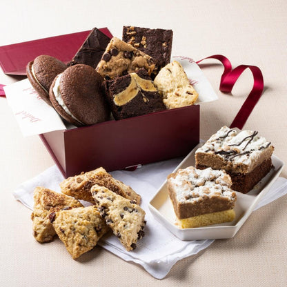 Pastry gift basket with assorted cookies, brownies, and cakes in a ribboned box