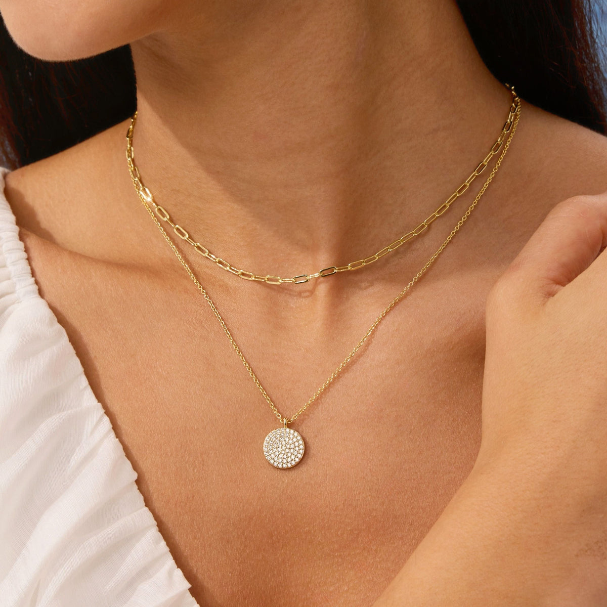 Layered gold necklace with pave disc pendant